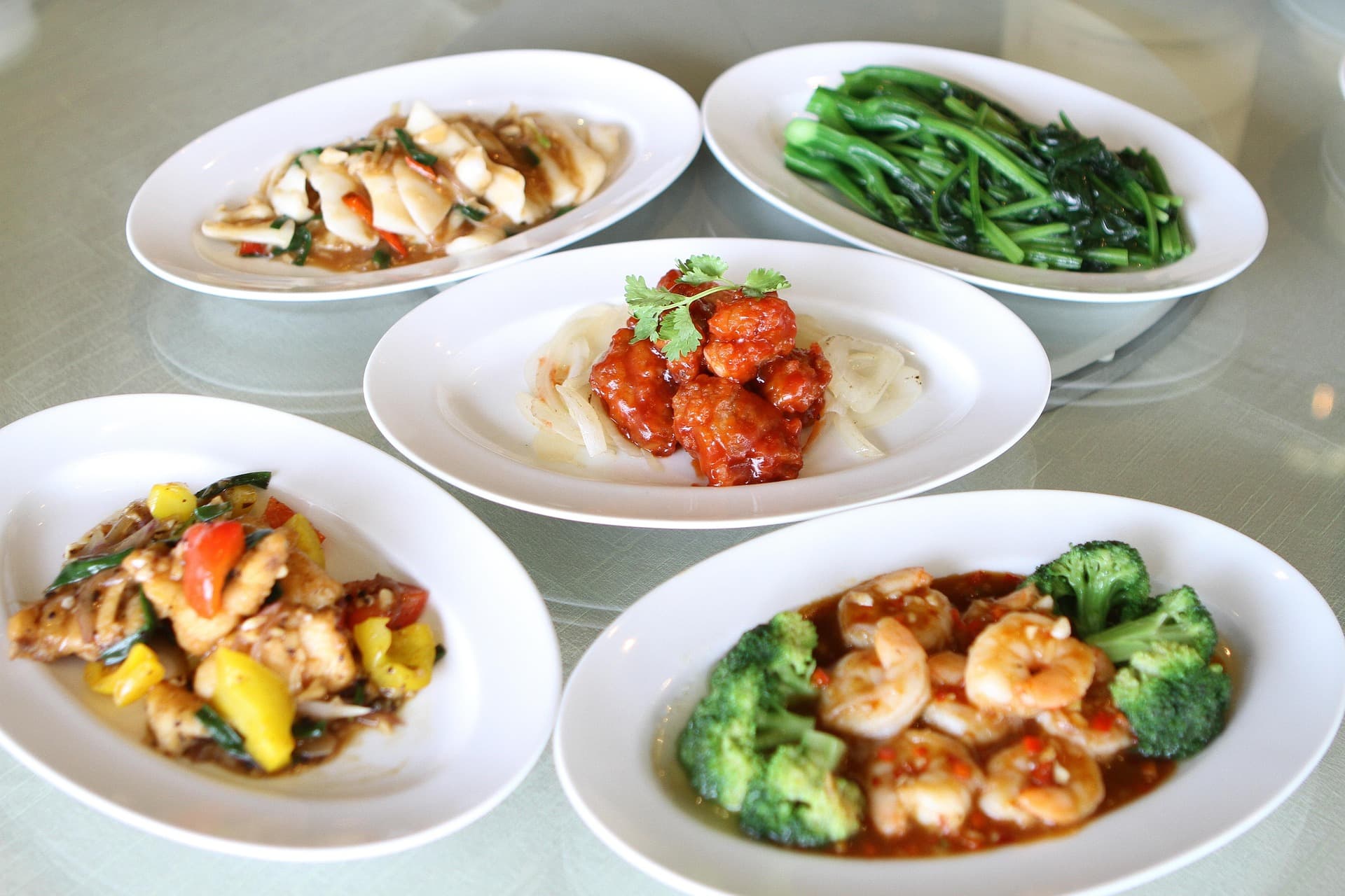 Traditional Chinese restaurant table setting with multiple dishes
